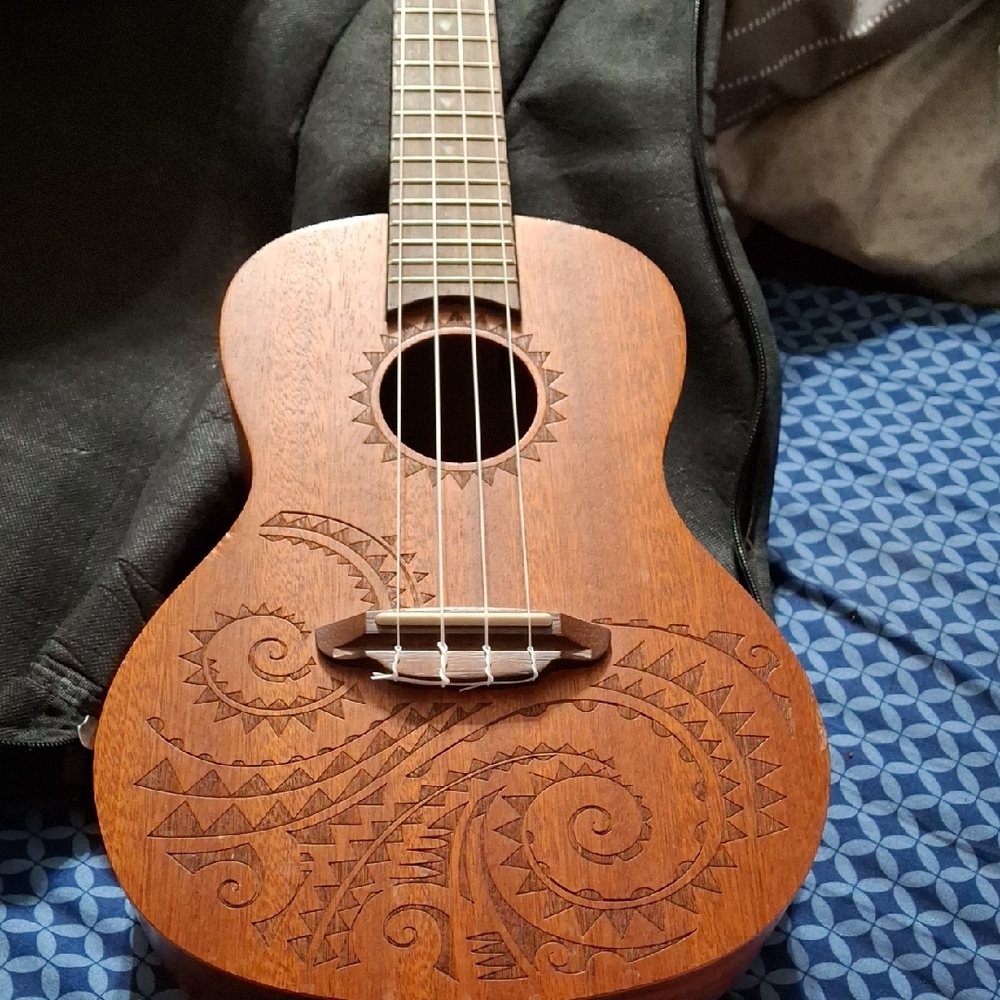 Intricately Carved Brown Ukulele